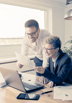 Advisors reviewing our software on a laptop